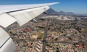 View from airplane window overlooking Cape Town city with Lion's Head mountain top.in the background.