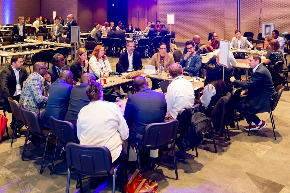 Men and women sitting around the table discussing at Africa Green Economy Summit