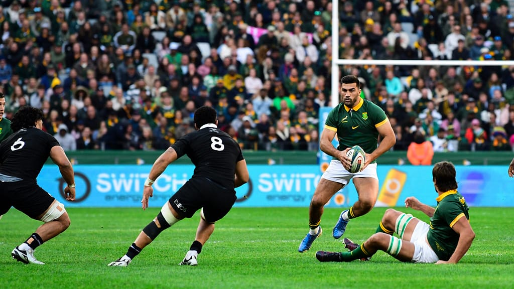 Springbok centre Damian de Allende takes on two All Blacks during a game at DHL Stadium