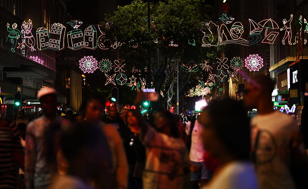 Residents and visitors on Adderley Street enjoying the assortment of festive lights on display
