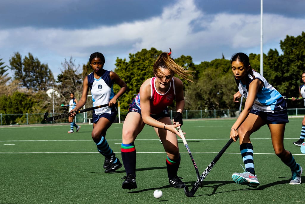young women hockey players on astro turf