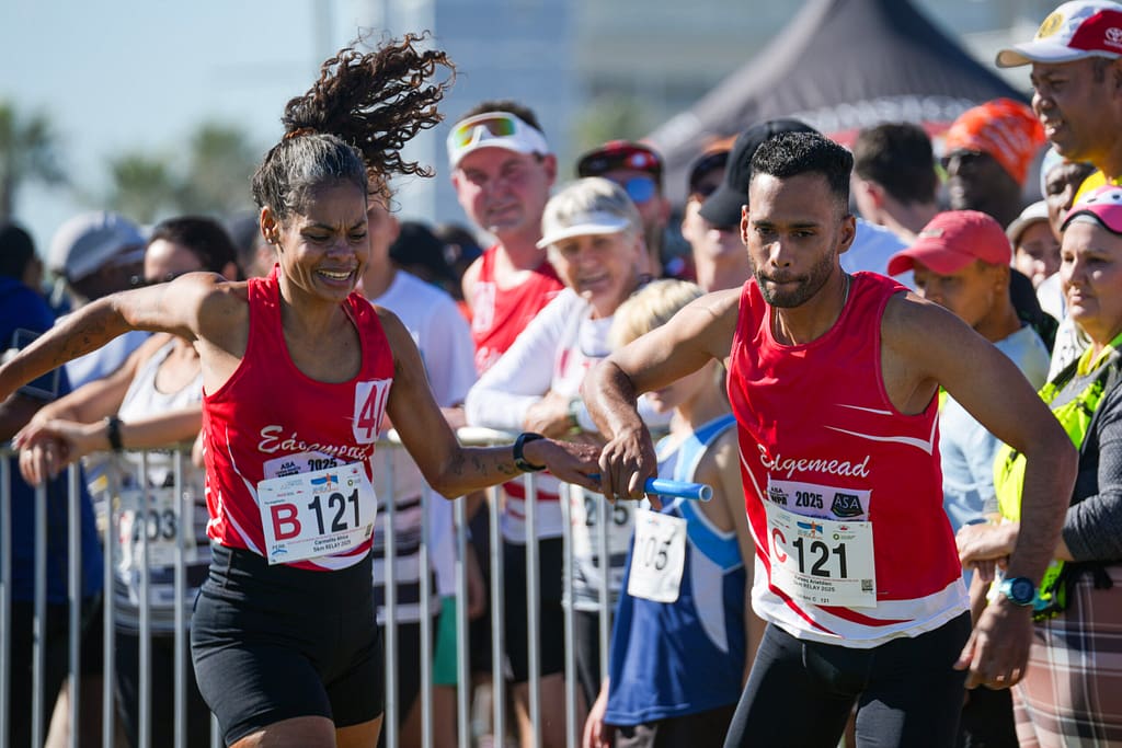Edgemead Club runners exchange a baton during a 5x5km relay at Cape Town Festival of Running 2025