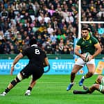 Springbok centre Damian de Allende takes on two All Blacks during a game at DHL Stadium