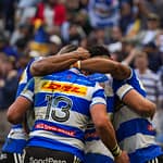 DHL Stormers players huddle after scoring a try