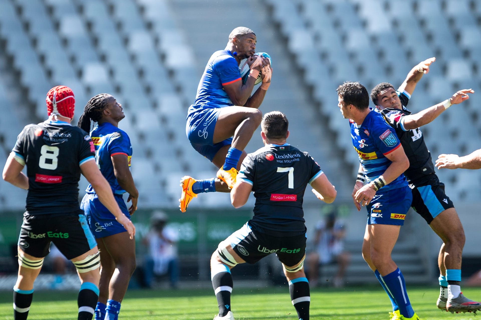 Rugby players catching rugby on rugby field at DHL Stadium