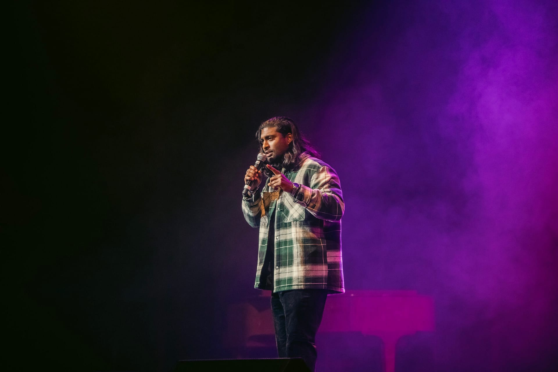 Jaryd Pillay on stage performing stand up comedy