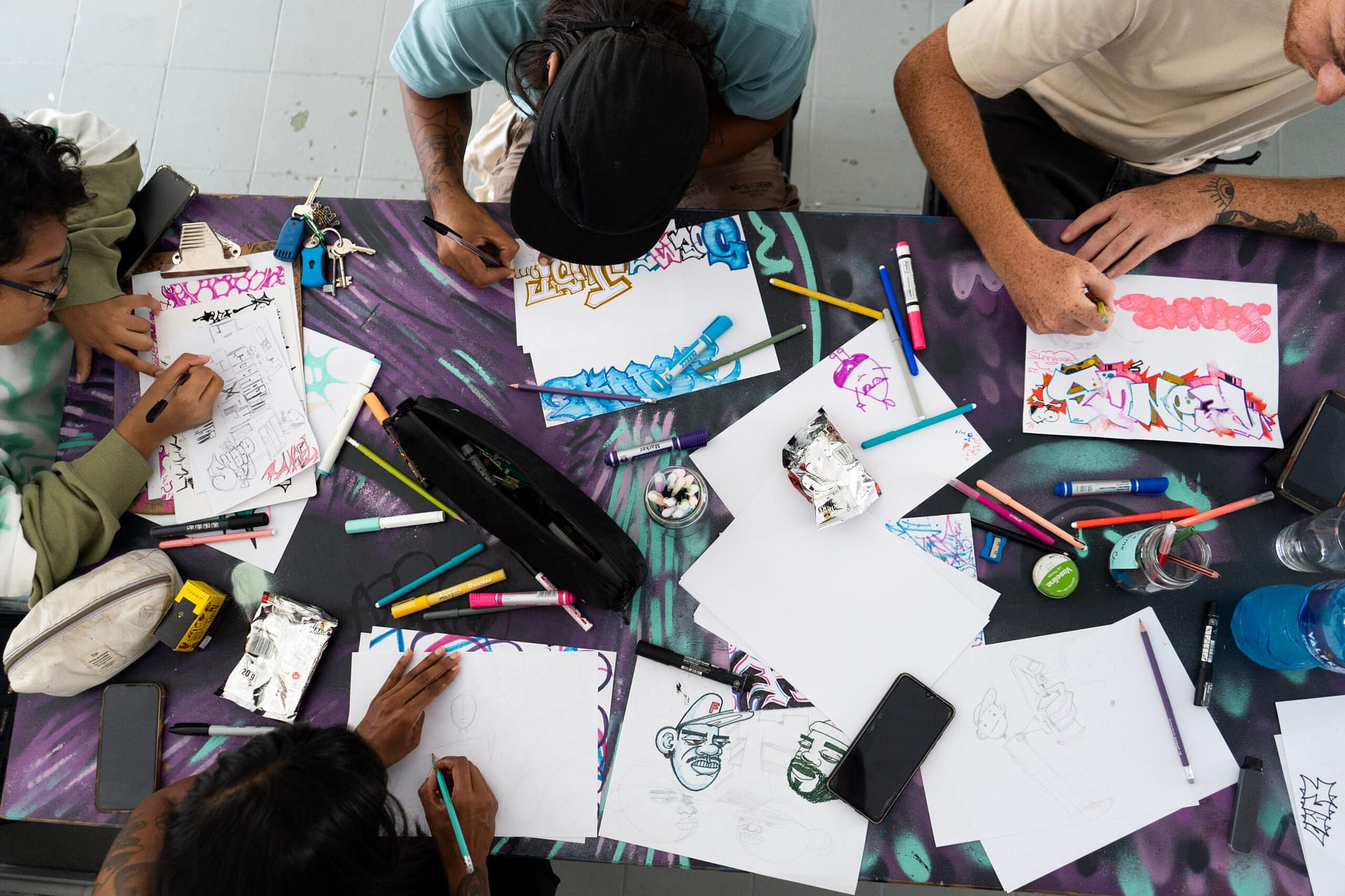 Khamissa Art Festival young people drawing and colouring on a table with pens and paper