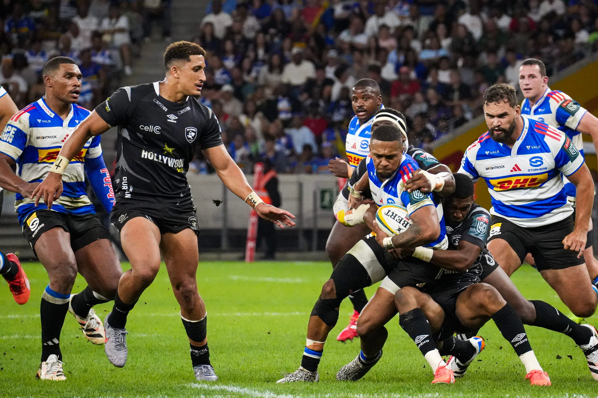 DHL Stormers winger Leolin Zas is tackled by Sharks players on his way to a try