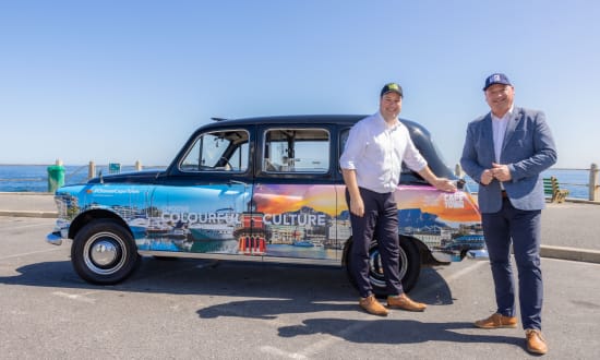 A London black cab featuring This is Cape Town signage.